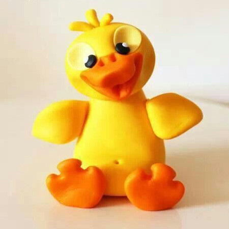 Finished polymer clay duckling in yellow and orange clay