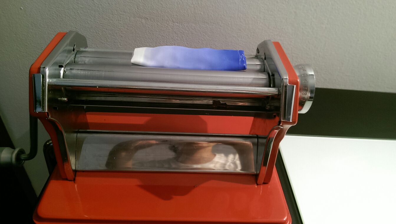 Conditioning FIMO clay by passing a sheet through a pasta machine