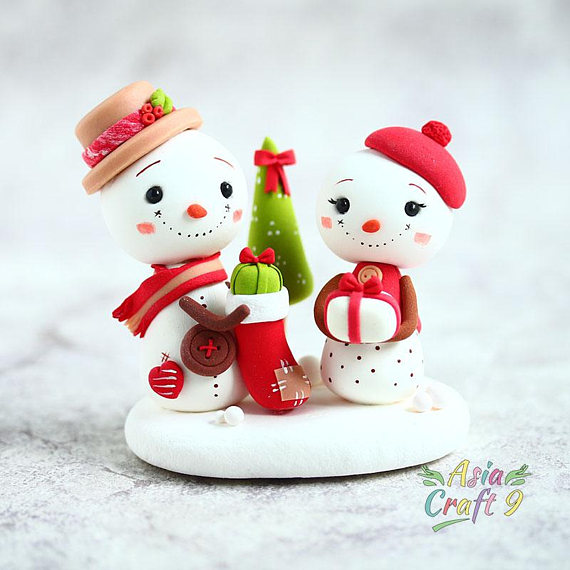 Snowman prepare gift in Christmas stocking clay figure, Snowman hold Xmas present with Christmas tree clay miniature, Christmas decoration