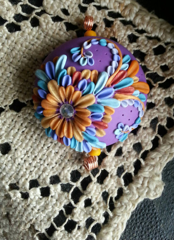 Bali inspired polymer clay floral embroider beads in shades of orchid, lavender, aqua, orange, rust, and yellows.