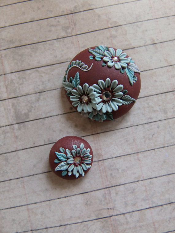 handcrafted polymer clay focal bead and accent bead set with a muted copper background