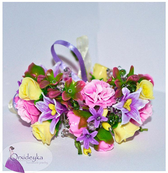 Handmade flower bracelet with fluffy blooming pink peonies, lilacs, pastel lilac lilies, lemon roses and beads.