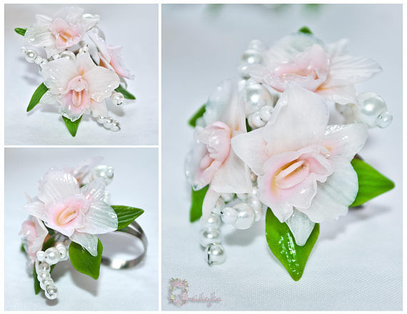 handmade flower ring with beautiful white orchids, green leaves and white beads.