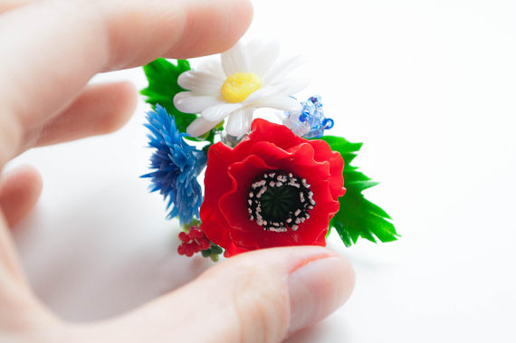 Exclusive handmade ring like a wonderful flower bouquet of blue cornflowers, red poppies and maiden daisies.