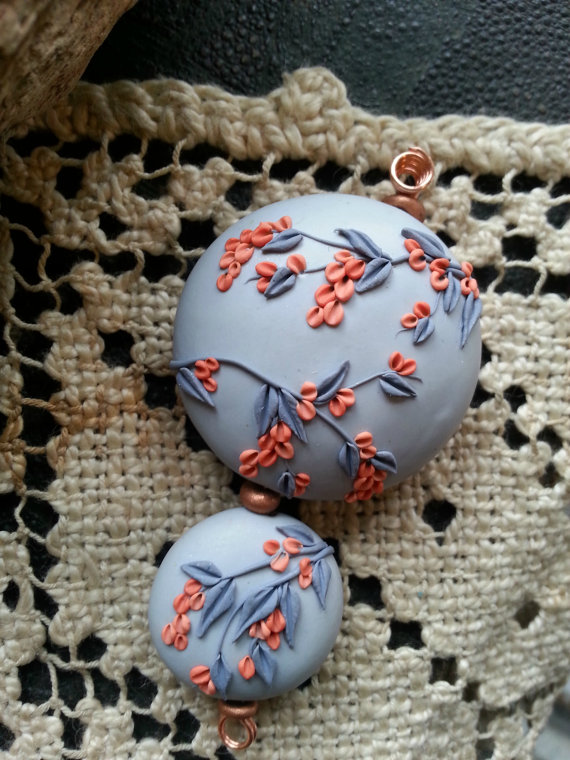 accent bead set with backgrounds of pale grey, and branches and leaves in coral/dark grey.