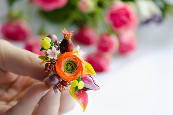 ring with orange buttercups (Ranunculus), briar berries and flowers. Nice gift to Birthday and other occasions for your dear women