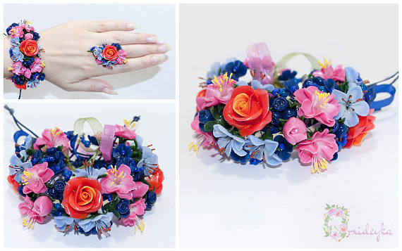 Exclusive handmade flower bracelet with gorgeous floral bouquet of warm red rose, pink and pale blue flowers, blueberries, cold green leaves and navy blue beads.