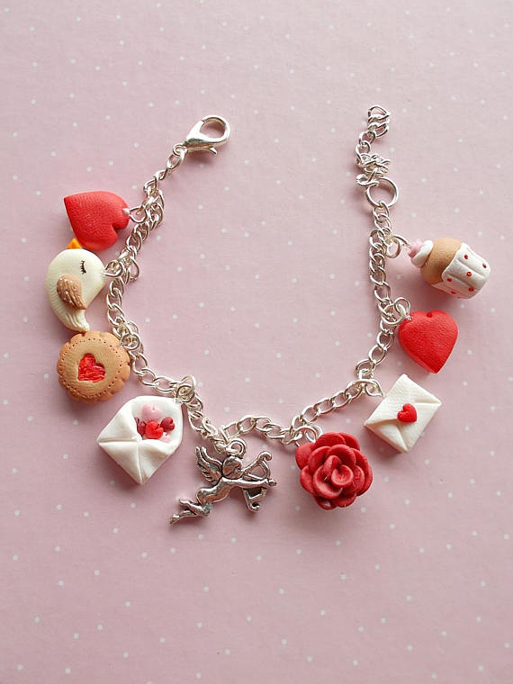 Adjustable Valentine's Day bracelet created from polymer clay with charms: love letter, rose, Cupid, envelope with red and pink hearts, bird, lovely muffin and the red heart charm. The bracelet is fully adjustable and can be worn by adults and children as well.